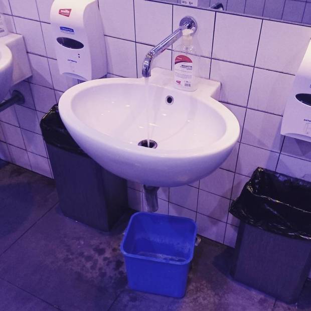 Roma Termini toilets, Rome Italy. Bucket under leaky sink